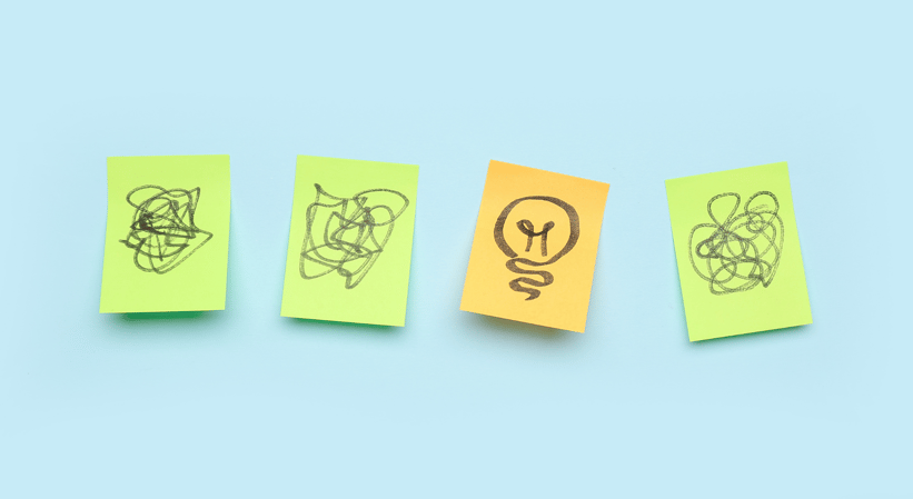 Four post-it notes: three with scribbles on them, and one with a hand-drawn lightbulb